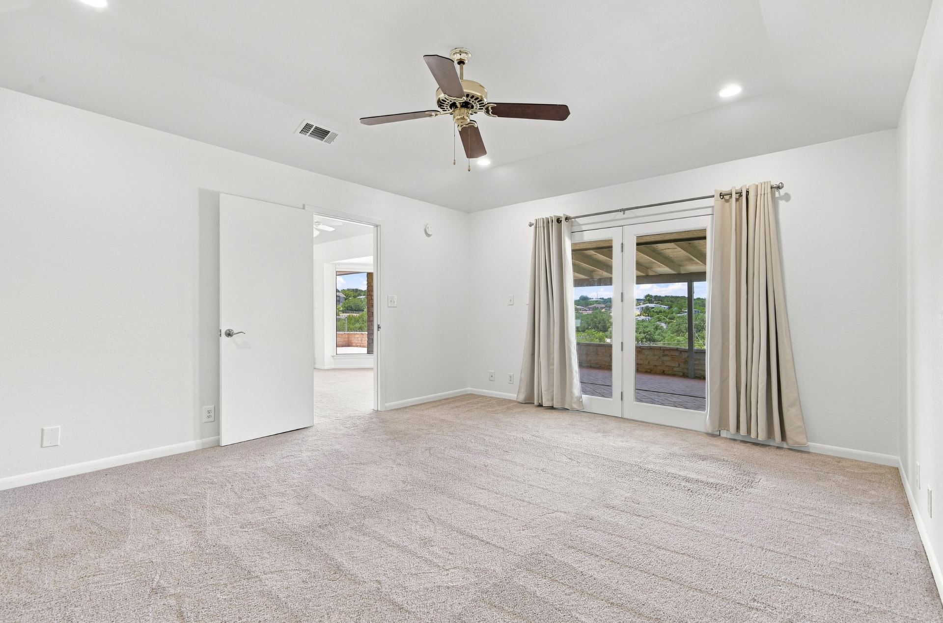 Bedroom with French doors opening to the covered terrace
