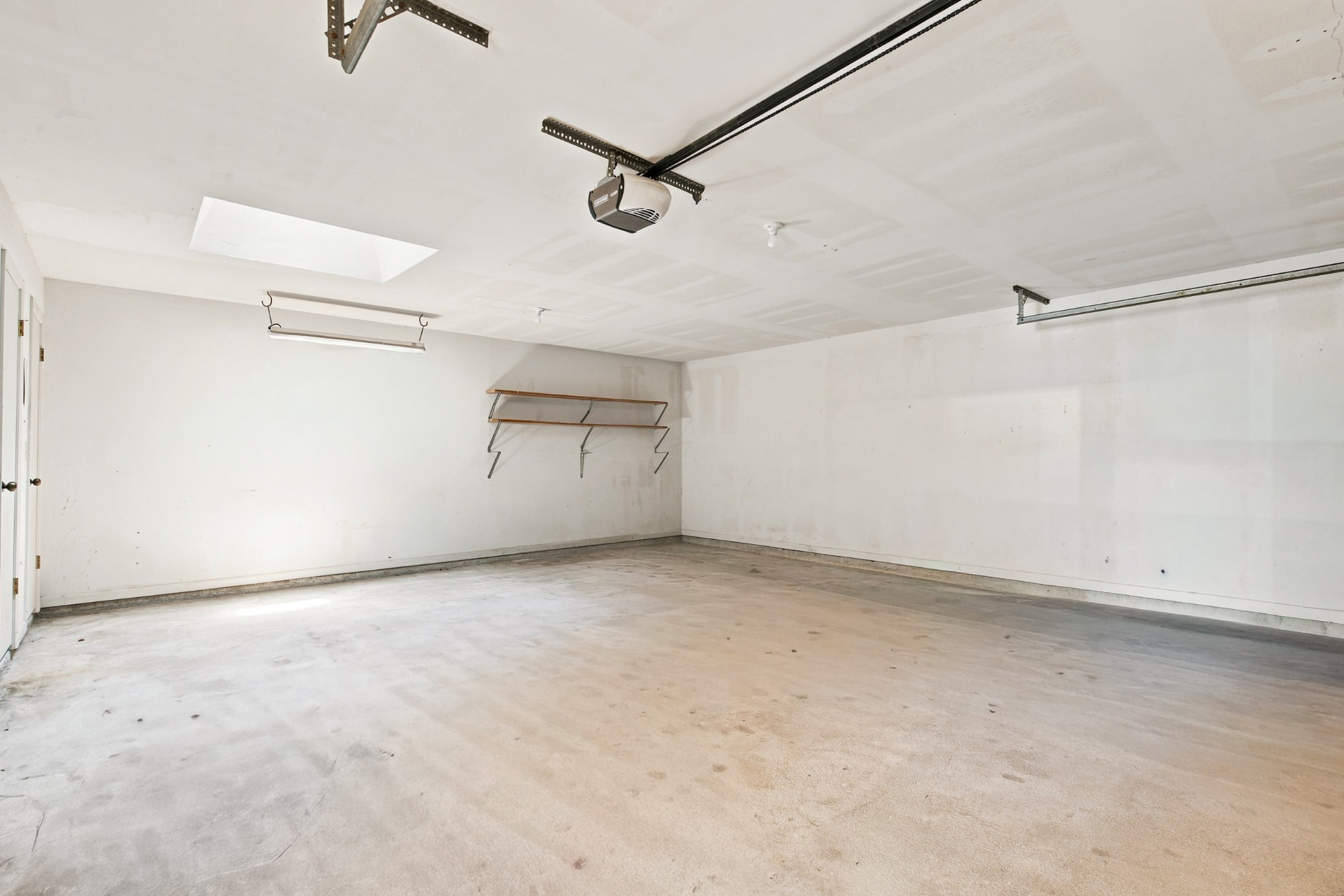 Oversized two-car garage with skylight and shelving