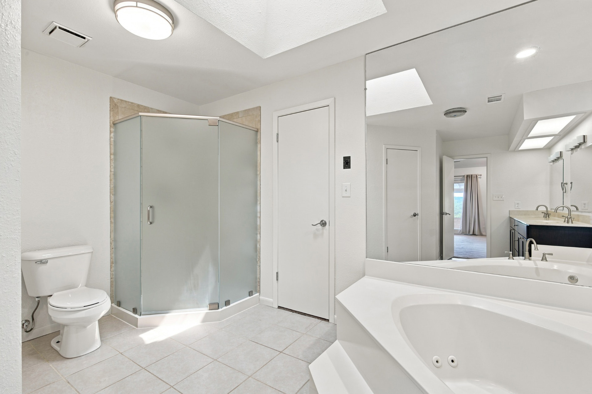 Bath with frameless corner shower and jetted tub