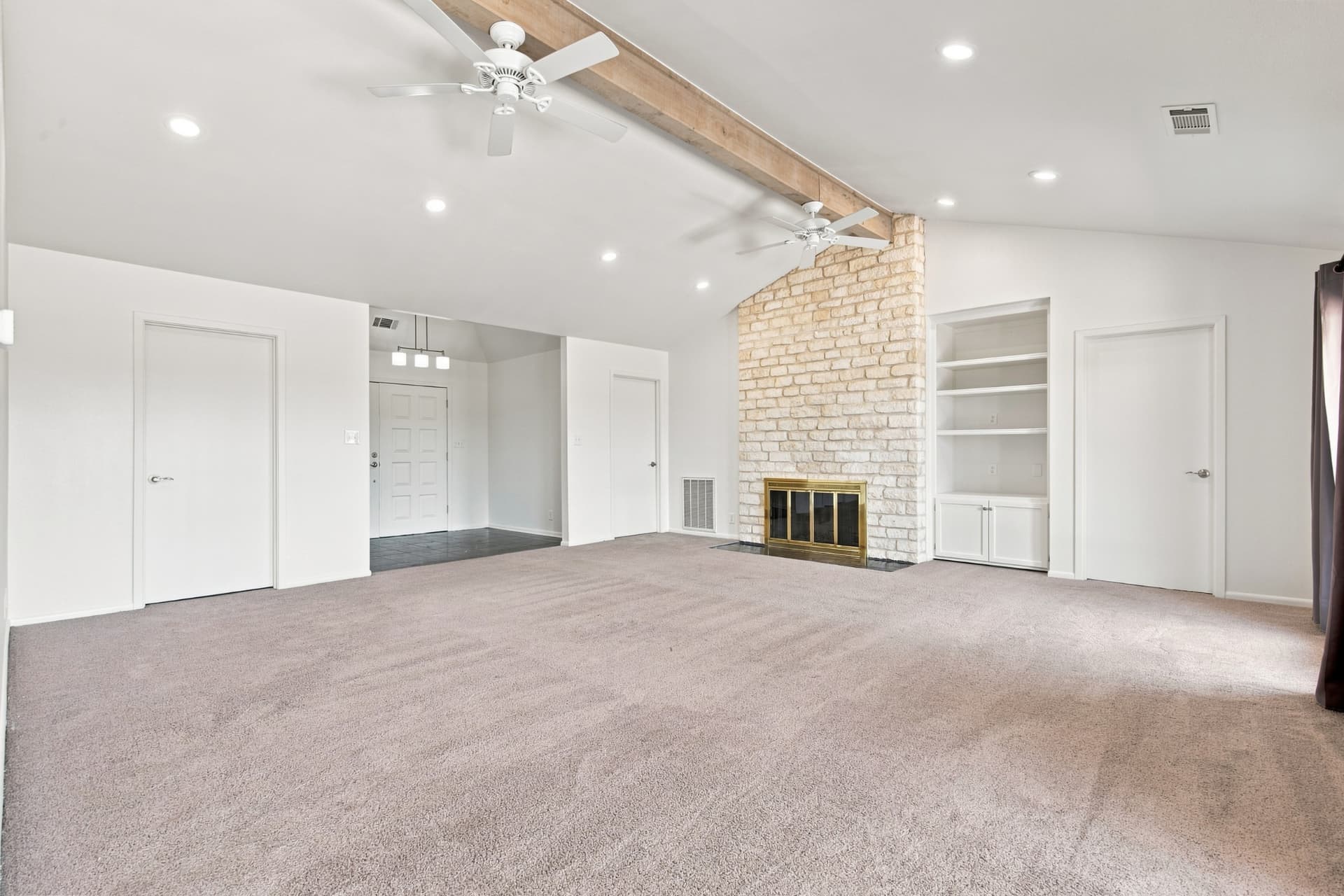 Living room with built-in shelving beside the fireplace