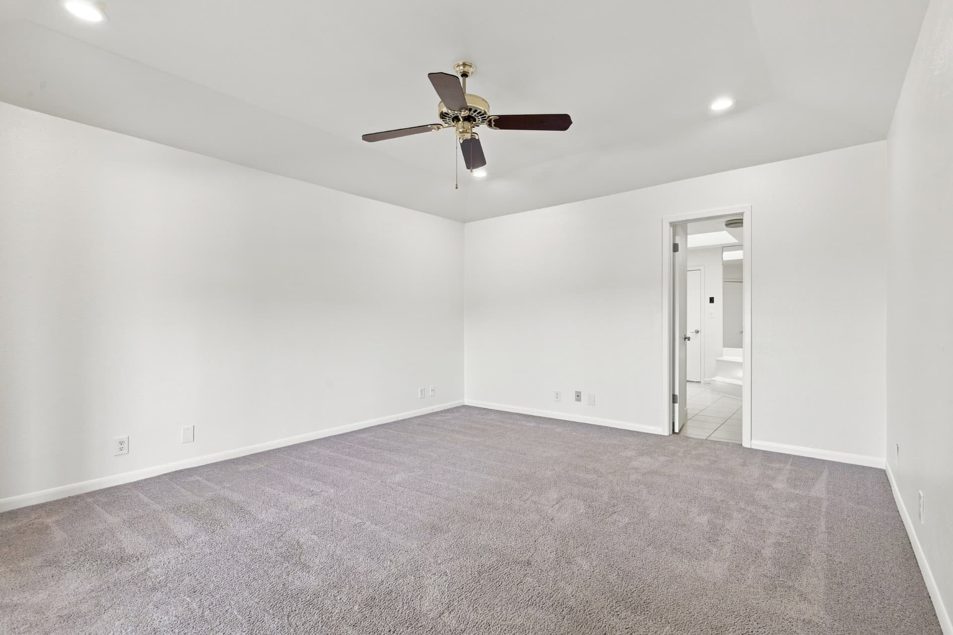 Carpeted bedroom with private bath entry