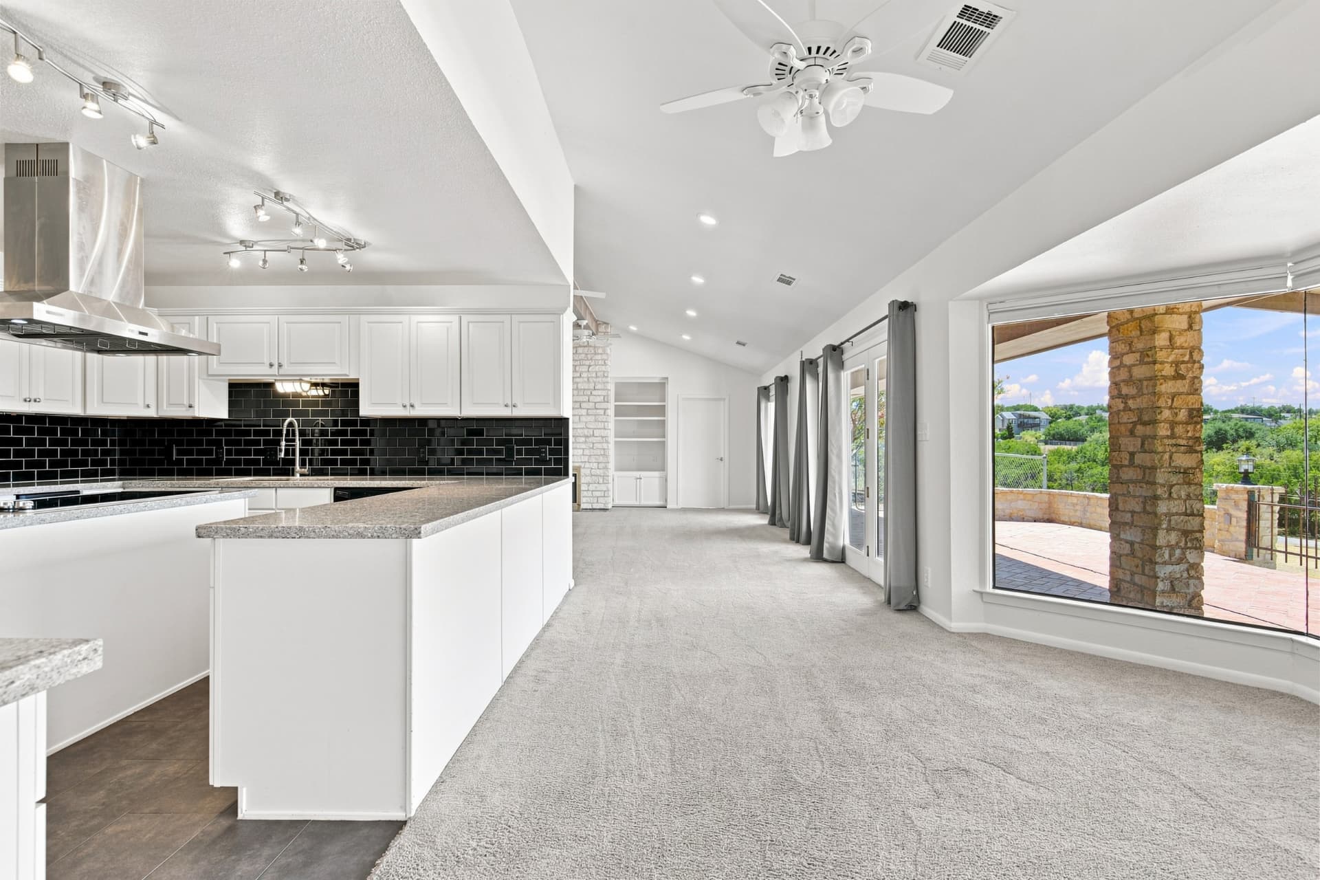 Dining area open to the kitchen with a wall of windows
